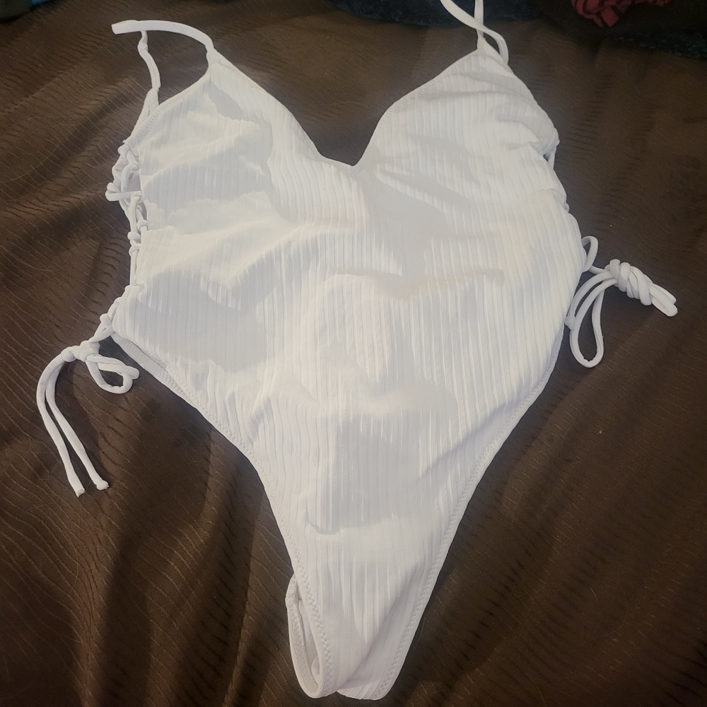 White bathing suit. One piece
